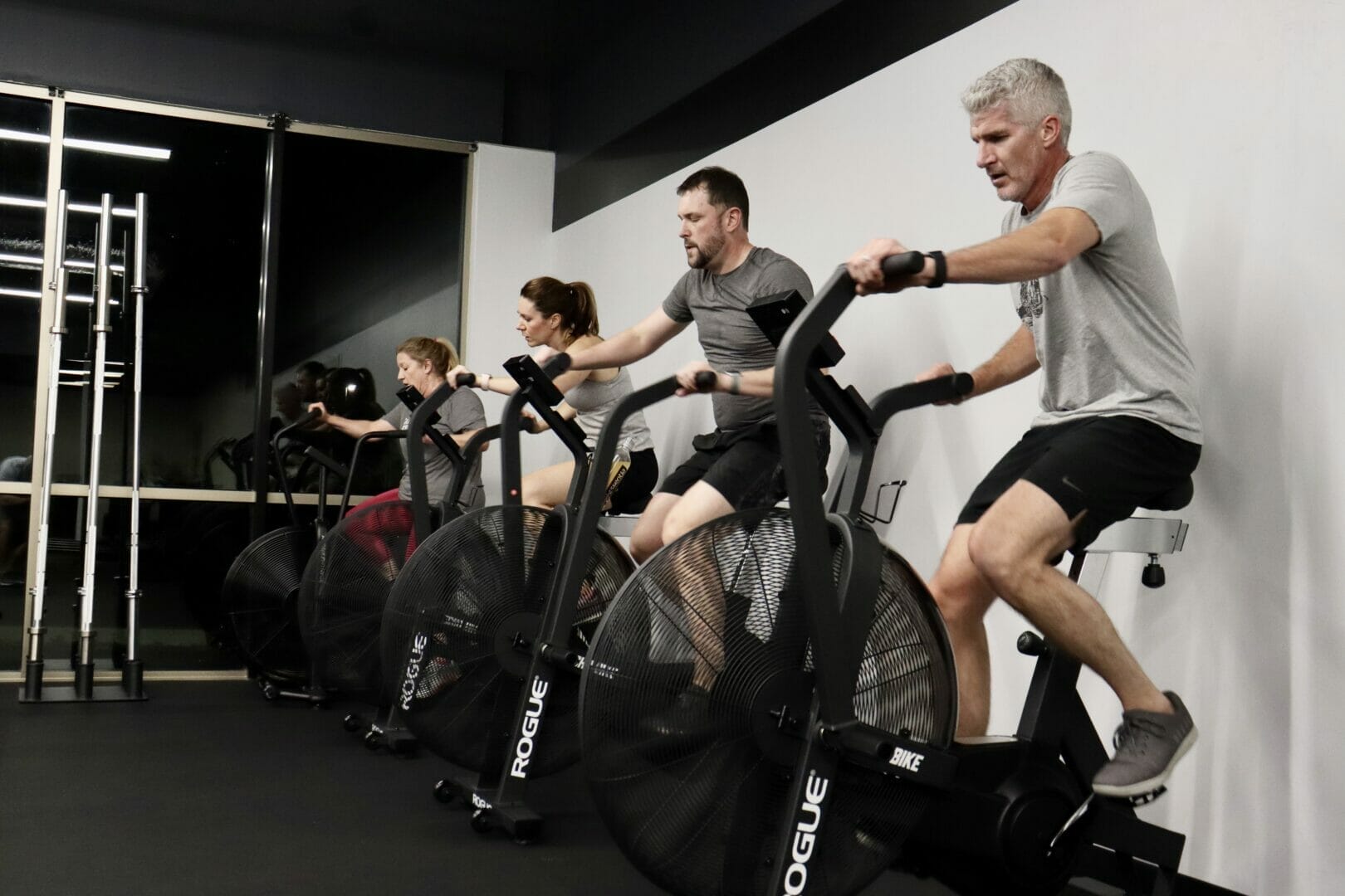 Gym Members on Air Bike Exercising.