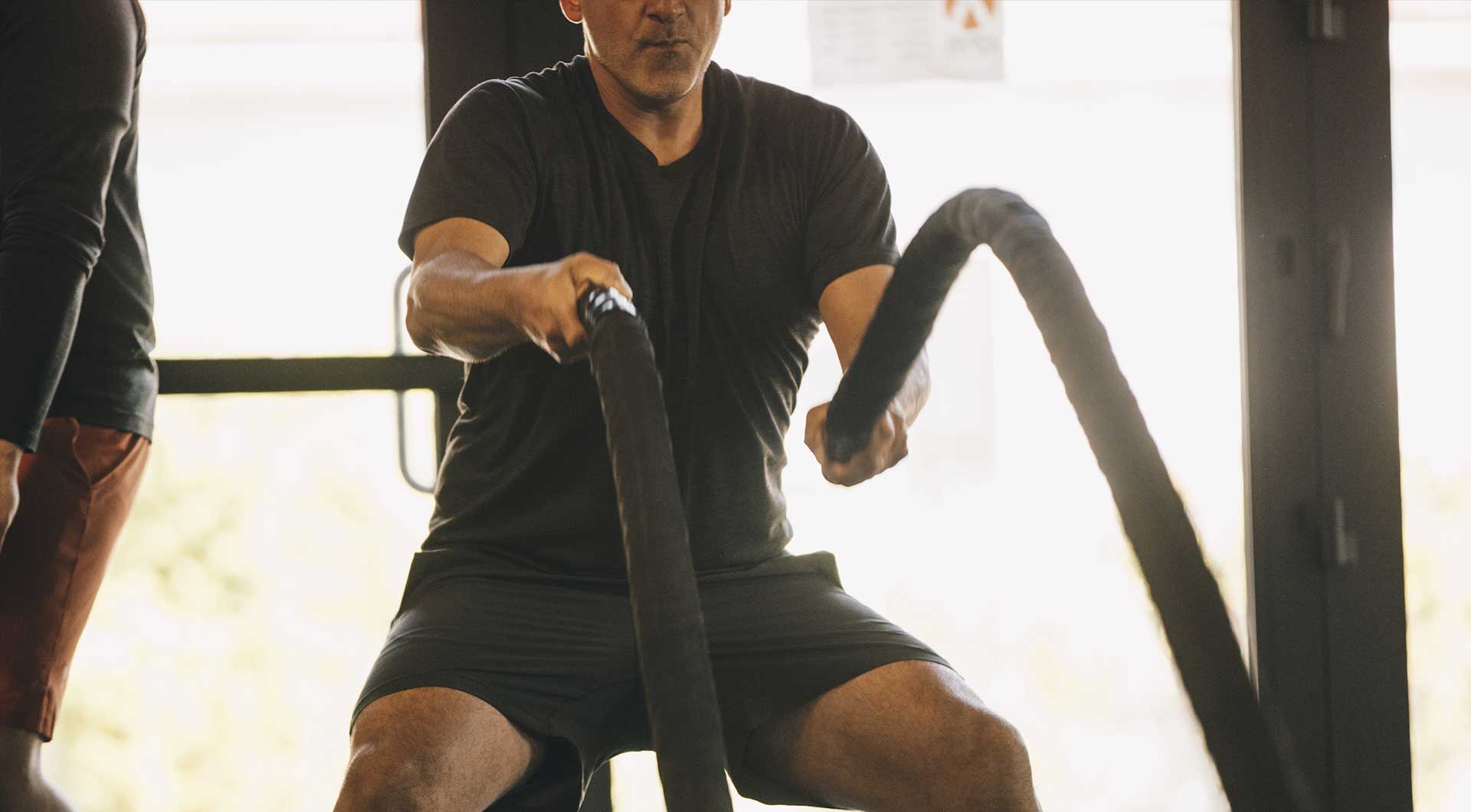 Man with the ropes on crossfit class