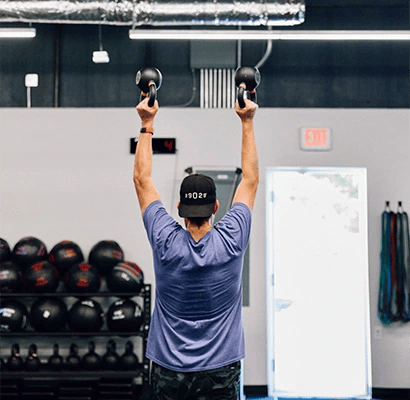 man training with dumbbells at Fit One Five